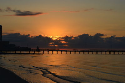 Scenic view of beach against sky during sunset