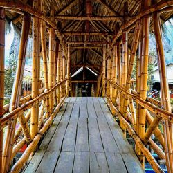 Low angle view of old bridge amidst buildings