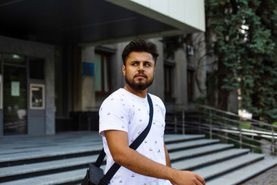 Portrait of young man standing outdoors