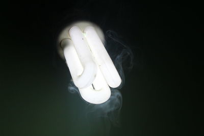 Close-up of light bulb against black background