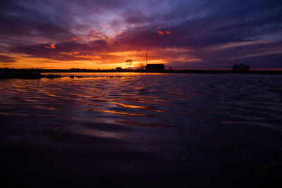 A dramatic sunrise over the pond with color reflections.