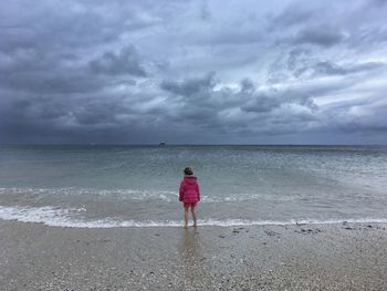 Rear view of man walking on beach