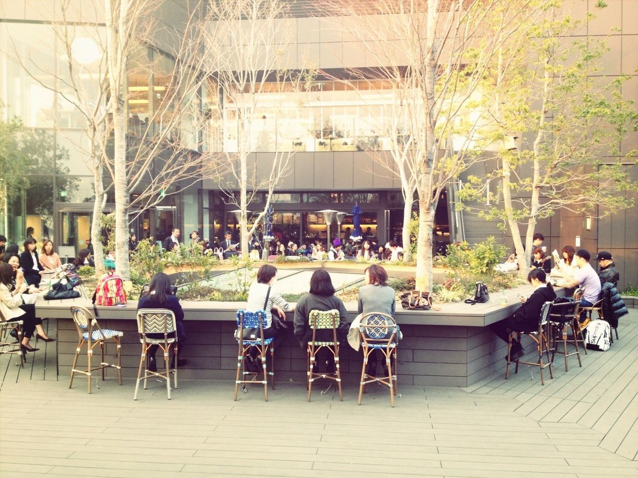 chair, table, person, men, sitting, indoors, lifestyles, built structure, architecture, restaurant, bench, leisure activity, sidewalk cafe, relaxation, building exterior, seat, empty, potted plant, medium group of people