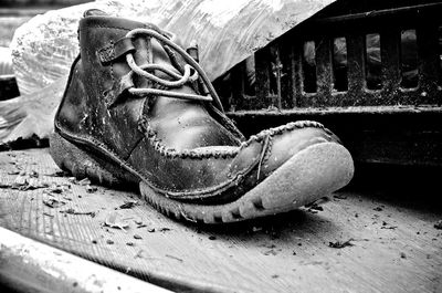 Close-up of old shoes on wood