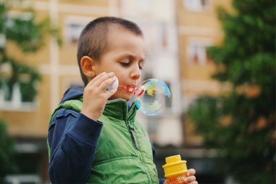 Close-up of boy holding bubbles