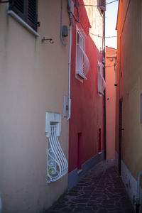 Empty alley amidst buildings in city