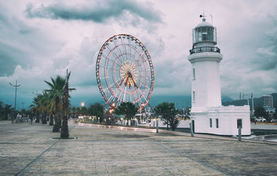 View of ferris wheel against cloudy sky