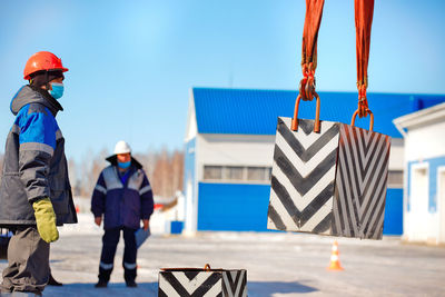 Construction worker looking at hanging barrier