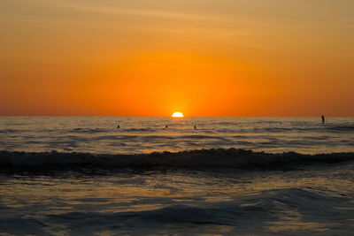 Scenic view of sea against orange sky