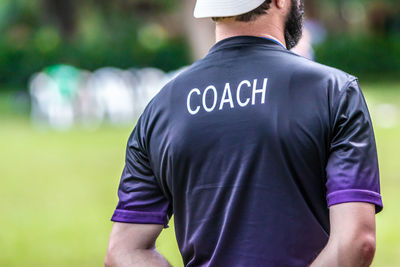 Rear view of man standing against blurred background