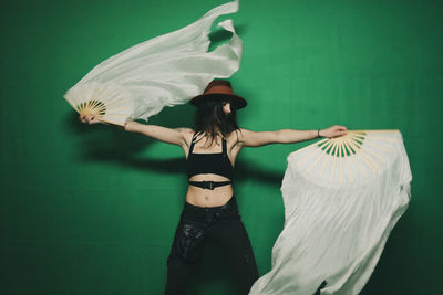 Rear view of woman standing against wall