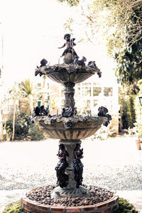 Statue of fountain against plants