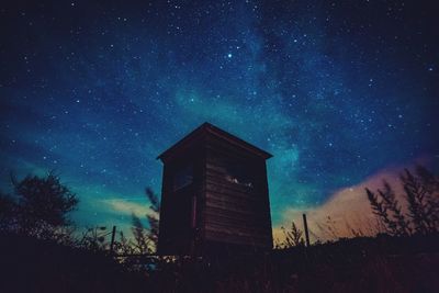 Low angle view of buildings against sky at night