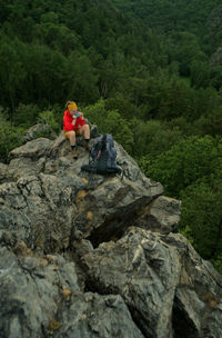 Hiker sitting on rocky mountain