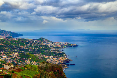 High angle view of townscape by sea against sky