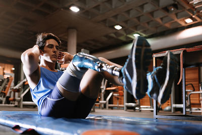 Man with artificial leg exercising in gym