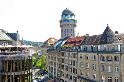 Buildings in town against clear sky