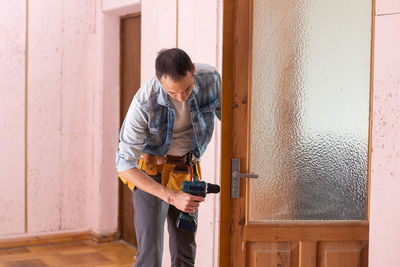 Man reparing door at home
