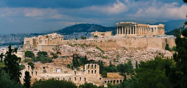 View of acropolis against cloudy sky