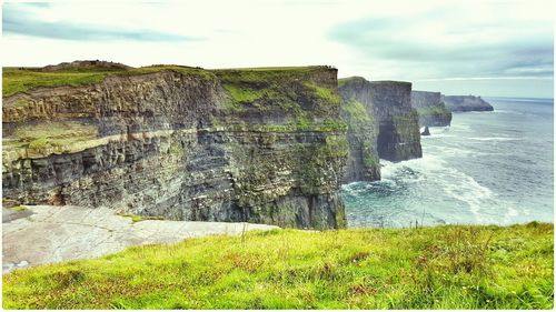 Scenic view of sea against cloudy sky