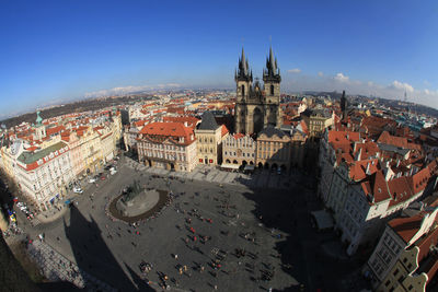 Aerial view of people walking at old town square against sky