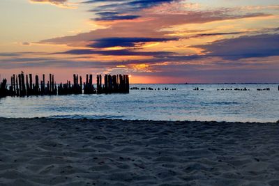 Scenic view of beach against sky during sunset