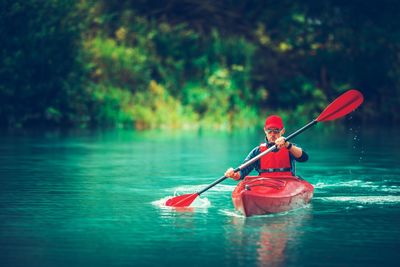 Man kayaking in lake