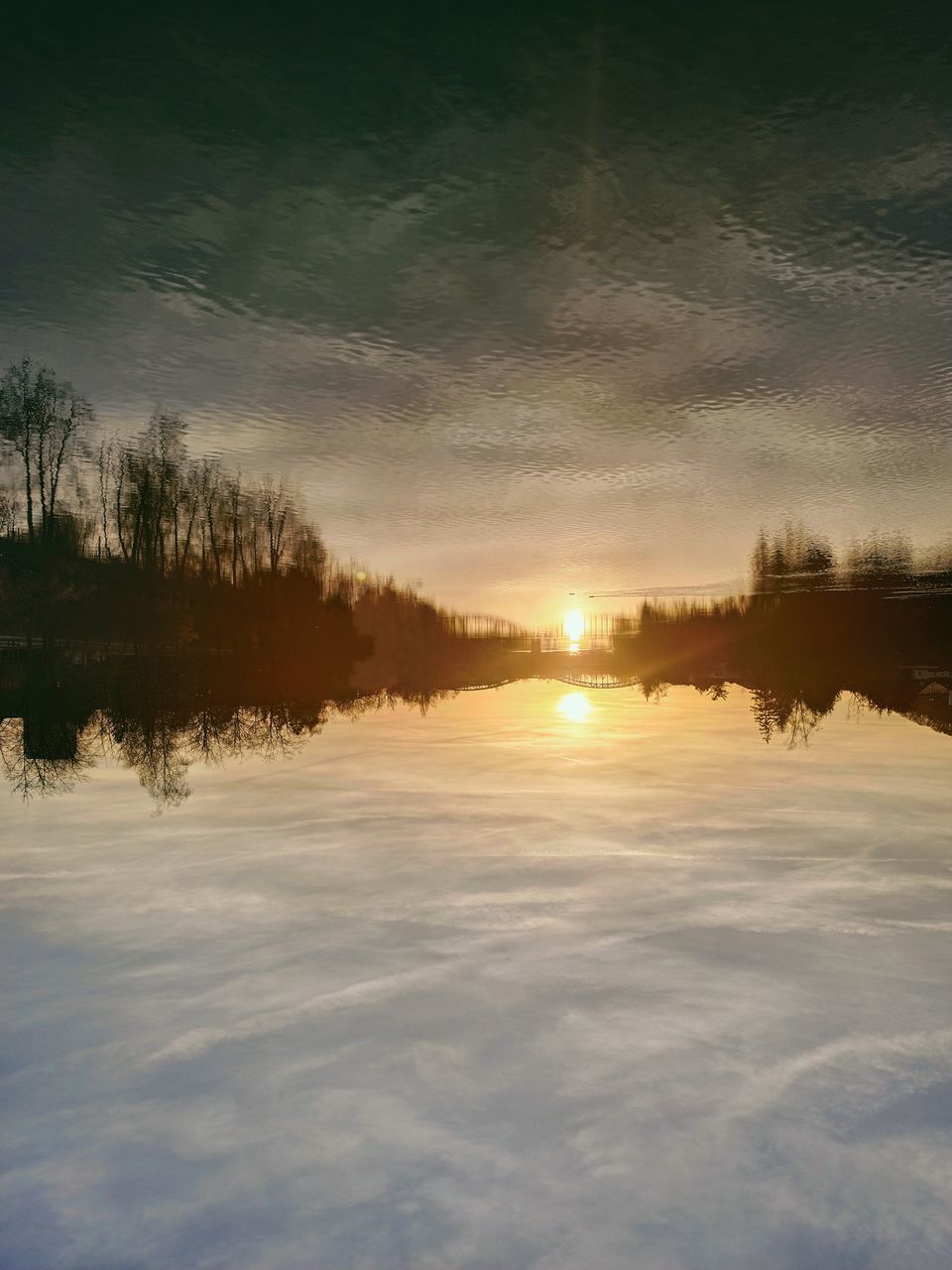 sky, reflection, morning, tree, beauty in nature, cloud, nature, dawn, tranquility, scenics - nature, sunlight, water, sunrise, tranquil scene, environment, plant, sun, snow, no people, landscape, lake, cold temperature, winter, idyllic, outdoors, land, non-urban scene, frozen, horizon, forest, dramatic sky