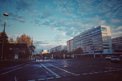 Buildings in city against cloudy sky