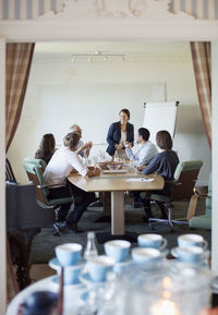 View of business people in conference meeting through doorway