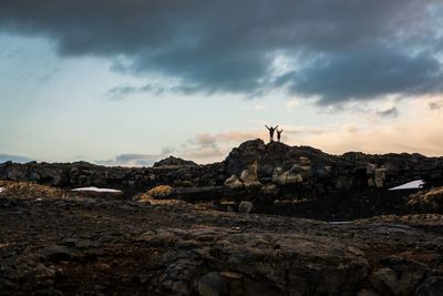 Rock formations on land against sky during sunset