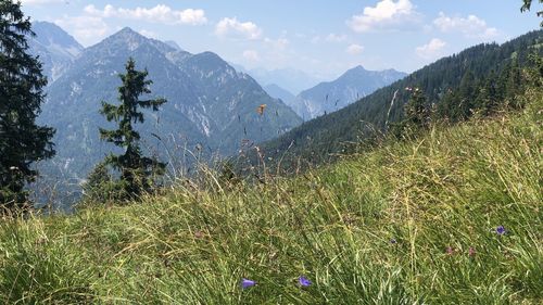 Scenic view of land and mountains against sky