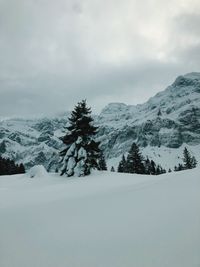 Scenic view of snow covered mountains against sky