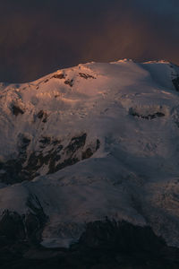Scenic view of snowcapped mountains against sky during sunset