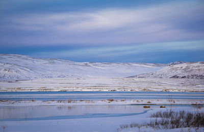 Scenic view of snowcapped mountains against sky during winter