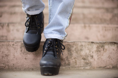 Low section of man wearing shoes standing outdoors