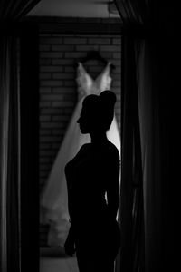 Silhouette woman standing at home