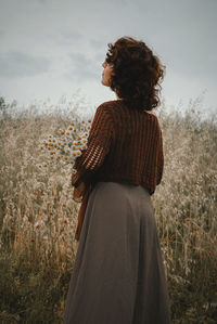 Rear view of woman standing on field