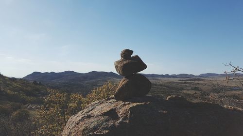 Man on mountain against clear sky