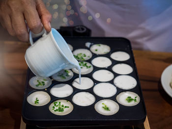 Close-up of hand holding food on table