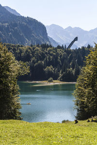 Scenic view of lake and mountains against clear sky