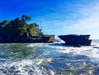 Scenic view of sea against blue sky