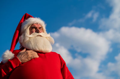 Low angle view of santa claus against sky