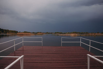 Pier over lake against sky