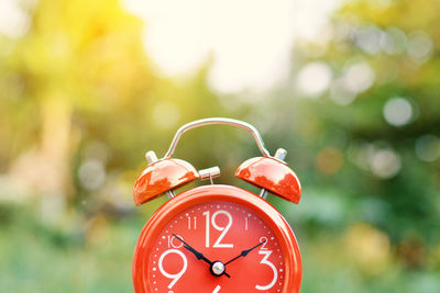 Close-up of red alarm clock outdoors