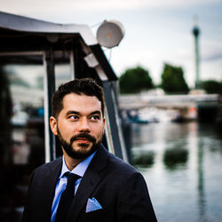 Man looking away against lake