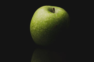 Close-up of apple against black background