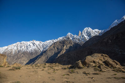 Scenic view of snowcapped mountains against clear blue sky