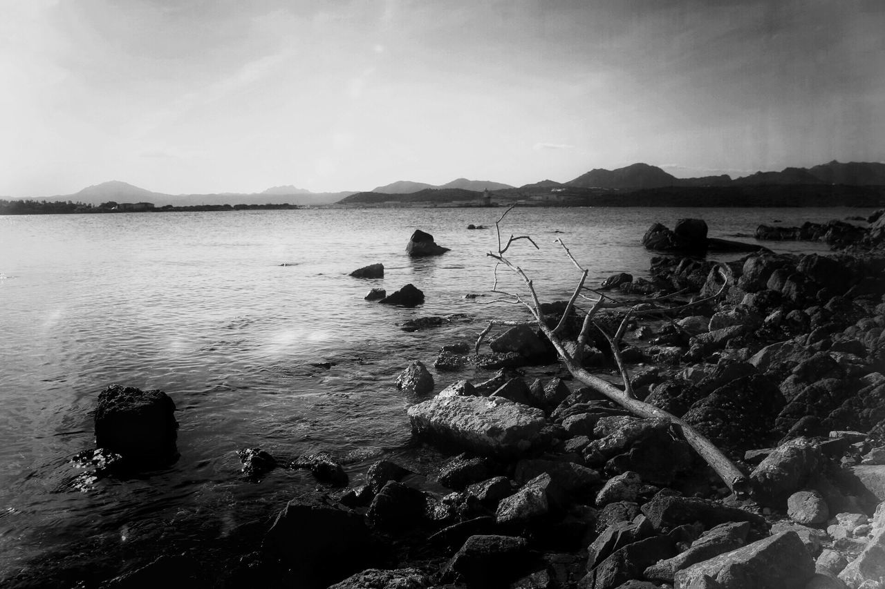 water, nature, rock - object, scenics, beauty in nature, tranquility, sky, tranquil scene, mountain, outdoors, no people, sea, day