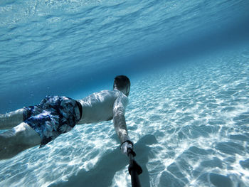 Go pro selfie of man swimming underwater